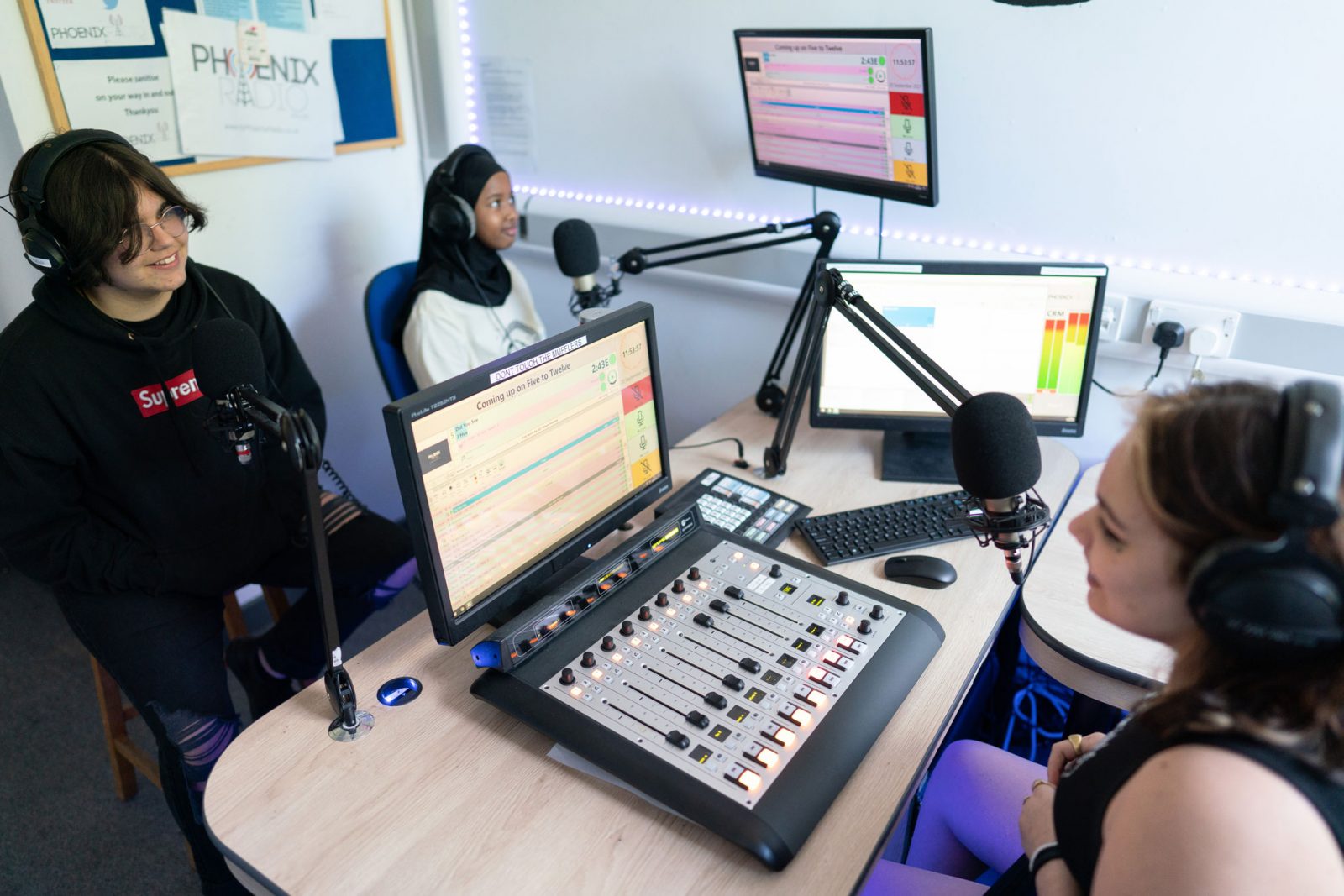 Three students sat in radio studio